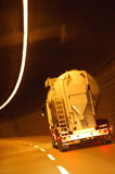 White+tanker+truck+driving+through+tunnel+lit+with+electrical+lighting