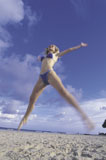 woman+jumping+on+beach