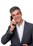 Assertive businessman using a mobile phone