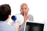 Confident businessman asking for silece while his colleague yelling through a megaphone