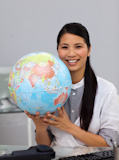 Assertive businesswoman holding a globe