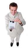 Positive businessman holding a book at the camera
