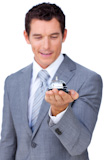Attractive businessman showing a ӥ bell