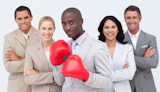 Businessman with boxing gloves leading his team