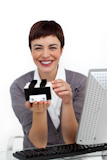 Smiling businesswoman holding a business card holder