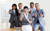 Successful business people with thumbs up