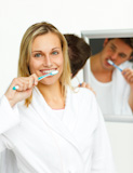Smiling,woman,cleaning,her,teeth,with,her,boyfriend
