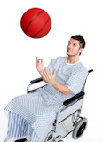 Patient in wheelchair having fun with a basket ball