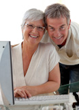 Happy senior couple using a PC