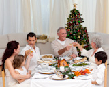 Grandparents and parents tusting in a Christmas dinner