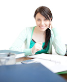 Delighted teen girl studying