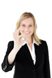 Handsomel businesswoman showing OK sign against a white ط