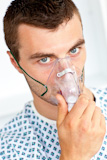 Patient having flu wearing a mask and looking at the camera
