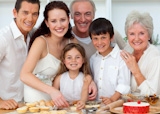 Portrait of parents, grandparents and children baking in the kitchen