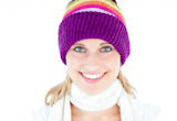 Glowing young woman wearing white pullover and colorful hat