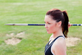 Concentrated athletic woman ready to throw the javelin