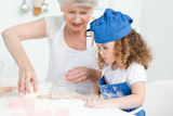 A,little,girl,,baking,with,her,grandmother