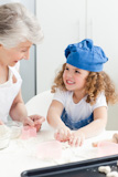 A,little,girl,,baking,with,her,grandmother