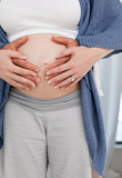 Couple's hand on the belly of the pregnant woman