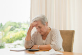Retired,woman,calculating,her,domestic,bills