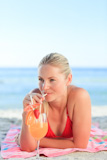 Cute woman drinking a cocktail