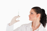 Female doctor preparing a syringe