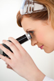 Scientist woman looking through a microscope
