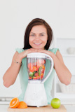 Smiling,young,woman,posing,with,a,blender