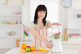 Attractive,brunette,woman,using,a,mixer,while,standing