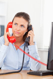 Businesswoman telephoning with two telephones