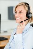 Portrait of a smiling businesswoman with headset looking elsewhere