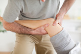 Chiropractor massaging a patient's knee