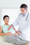 Doctor examining the belly of a pregnant woman