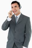 Male call center agent looking upwards while talking