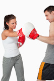 Female boxer listening to her instructor