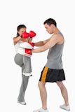 Female kickboxer practicing her knee technique