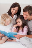 Portrait of a family reading a book