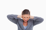 Close up of irritated tradeswoman covering her ears