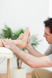 Podiatrist examining the foot of a patient