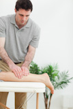 Close-up of a physiotherapist stretching the foot of a patient