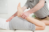 Close-up of a man massaging the leg of a woman