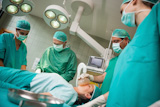 Surgeon using a scalpel to open a patient