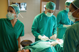 Group of surgeons working on a female patient