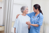 Close up of a nurse touching hand of a patient