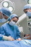 Doctors operating a patient