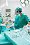 Surgeon operating an uncounscious patient in an operating theater
