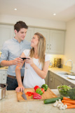 Couple drinking wine and cooking