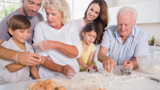 Multigeneration family cutting vegetables together