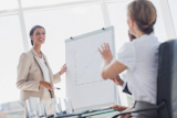 Businesswoman pointing at a growing chart during a meeting