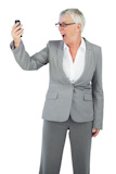 Excited businesswoman calling someone with her mobile phone
